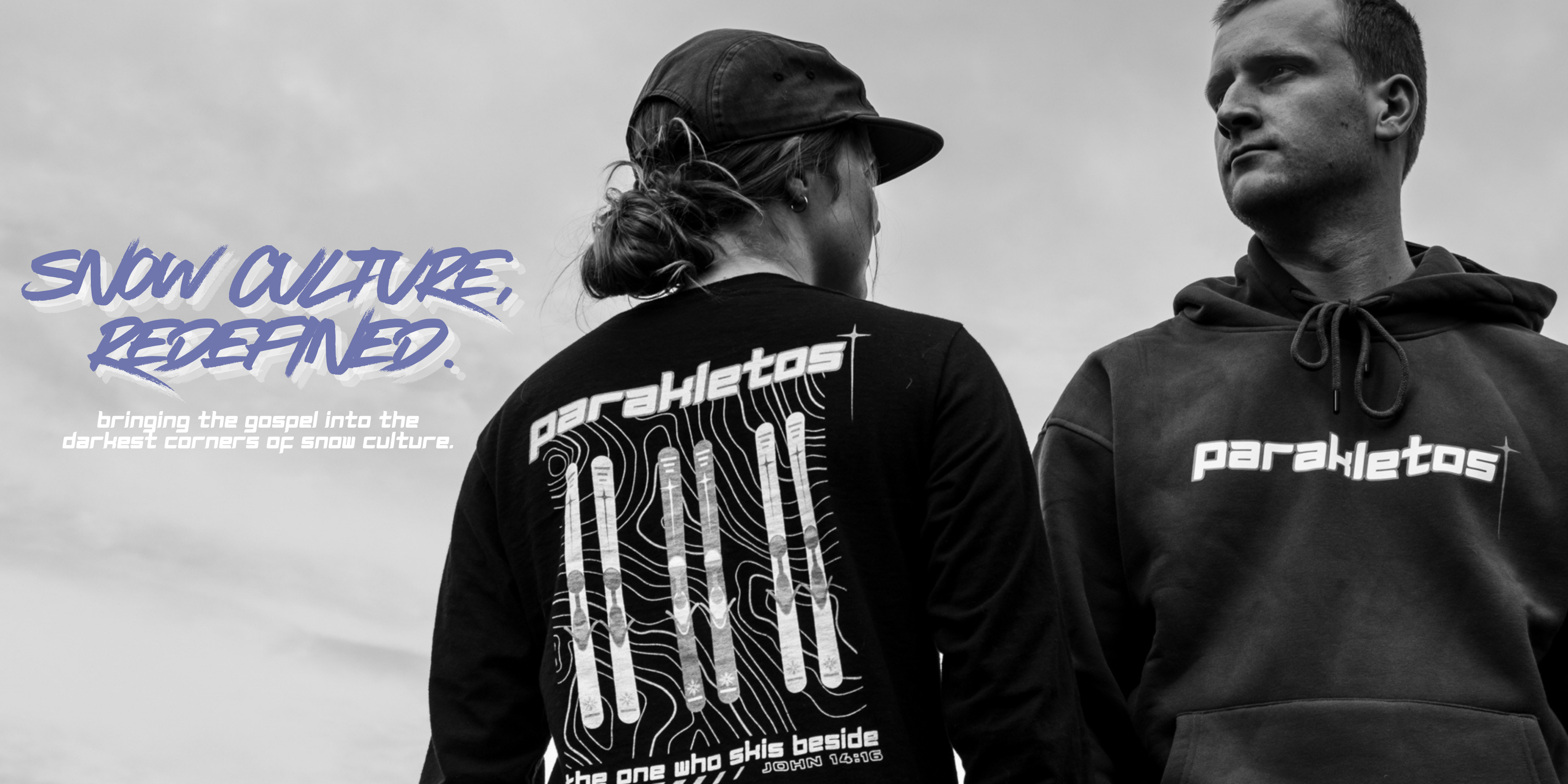 Two people wearing Parakletos apparel with text on a gray background